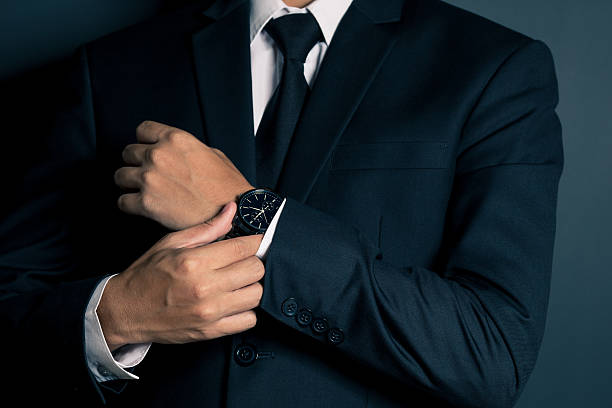istock Businessman Fixing Cufflinks his Suit 605779898