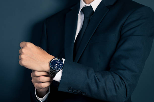 istock Businessman Fixing Cufflinks his Suit 605779938