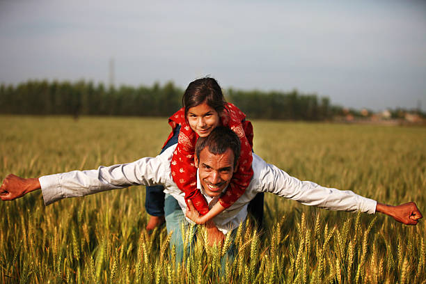istock Father giving his daughter a piggy back ride 605781798
