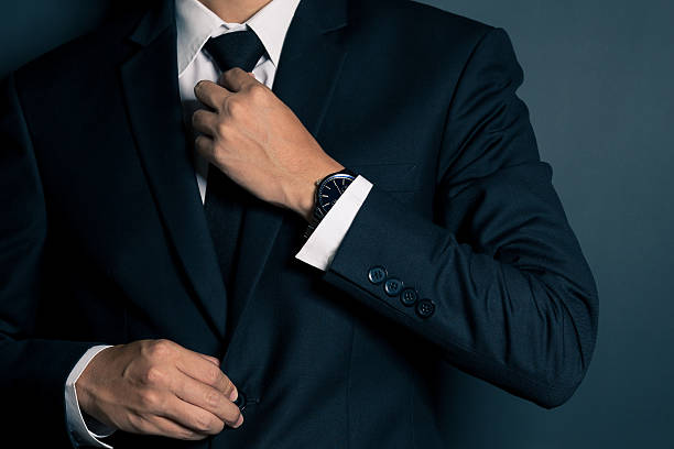 istock Businessman Adjusting His Necktie 605782094