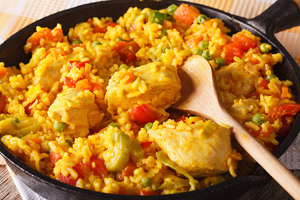 istock Arroz con pollo - rice with chicken in pan. Horizontal 605784076
