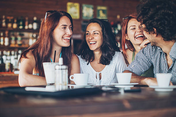 istock Three girls chatting with a young man 605785594