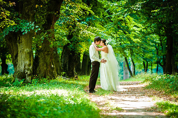 istock happy bride and groom on a walk in beautiful forest 605958242