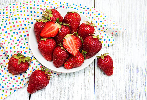 istock ripe strawberries on wooden table 605958302
