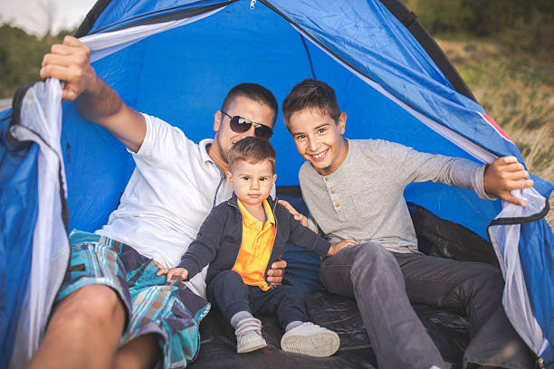 istock Family camping outdoors 605962540