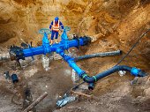 Worker underground on gate valve, reconstrucion of drink water system