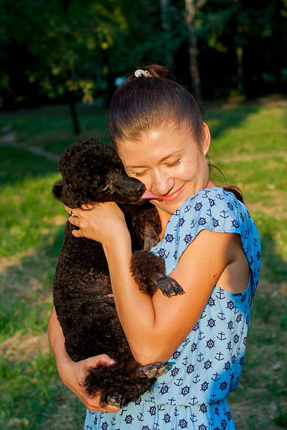 istock girl with black poodle 605966268