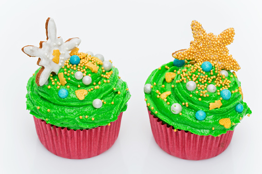 Christmas tree cupcakes over white background. Copy space.