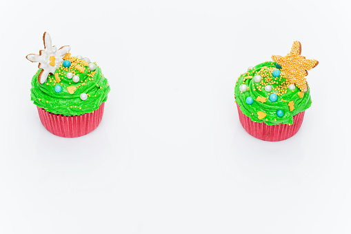 Christmas tree cupcakes over white background. Copy space.