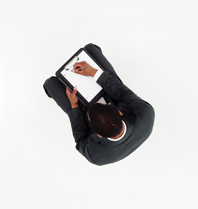 Above view of businessman writing on clipboardhttp://www.twodozendesign.info/i/1.png