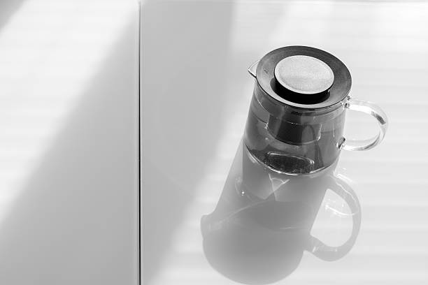 istock Transparent teapot on the white table. 605974818