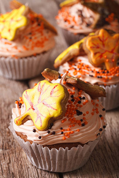 istock Autumn cupcakes decorated with cream and leaf. Vertical 605975276