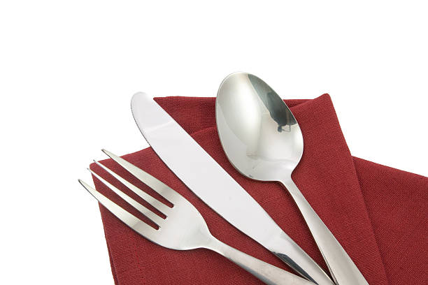 istock fork and knife on red napkin isolated 605981806