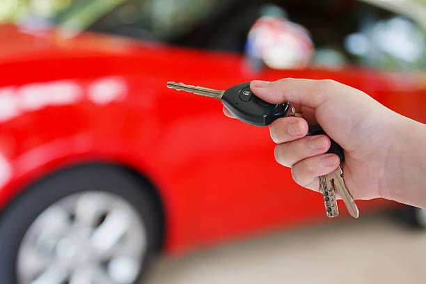istock women hand presses on the remote control car alarm systems 605981858