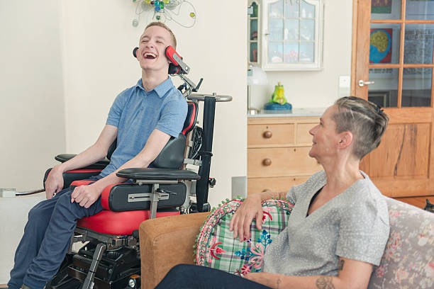 istock Happy cerebral palsy patient with his mom 605982394