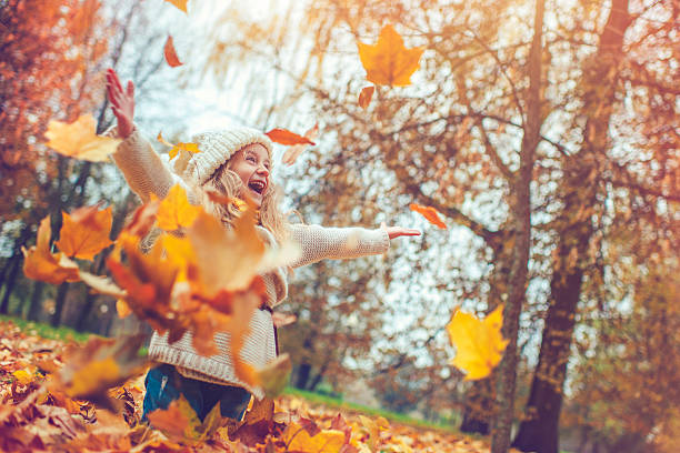 Little girl in autumn park Child in autumn catching photos stock pictures, royalty-free photos & images