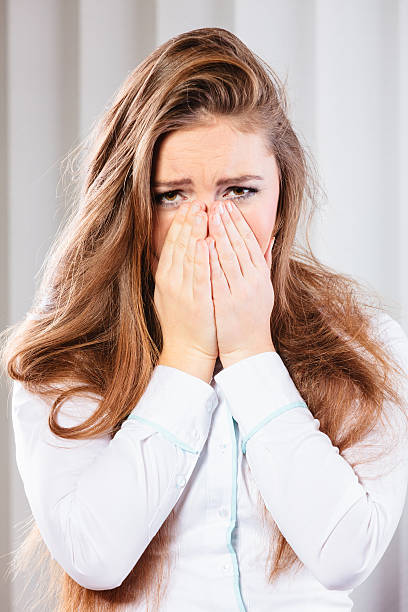 istock Sad woman cover face with hands 605987760
