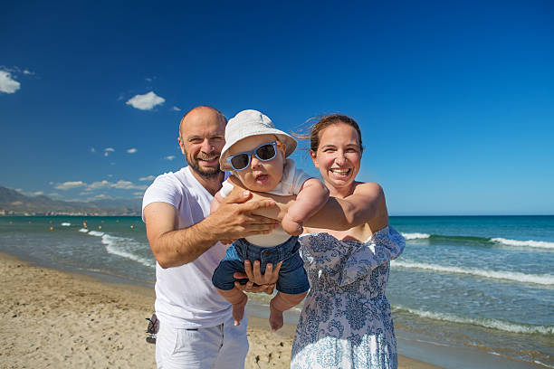 istock Family has fun at the seashore in summertime 605989938