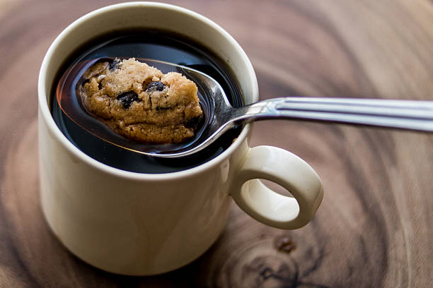 istock Chocolate Chip Cookie in the Coffee with Spoon. 605990920