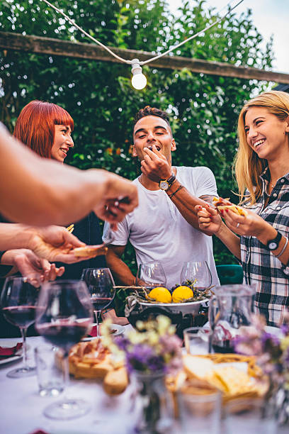 Group of friends enjoying together at a dinner party stock photo