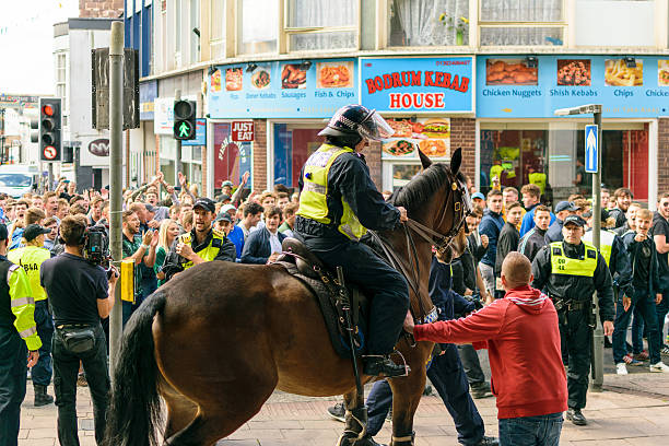 Police horse separates football fans stock photo