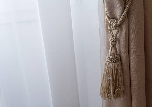 istock Beige curtains in a classic style. Interior 605994470