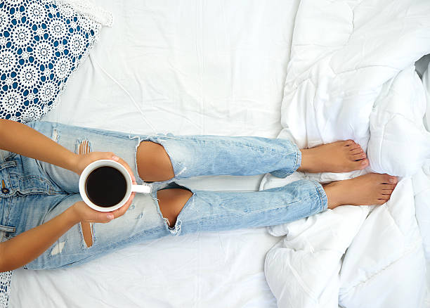 istock Young woman enjoying her coffee while sitting in bed. 605994758