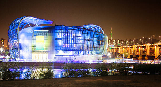 Seoul, South Korea- April 28, 2015: Seoul's Sebitseom some gavit illuminated complex at night. This new complex opened in 2015 and hosts numerous stores, conference halls, cafes and an elaborated LED looped light show at night. Banpo bridge is visible to the right as well as a small part of Seoul's skyline.