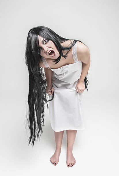 istock Mystical witch screaming woman looking at you 605997334