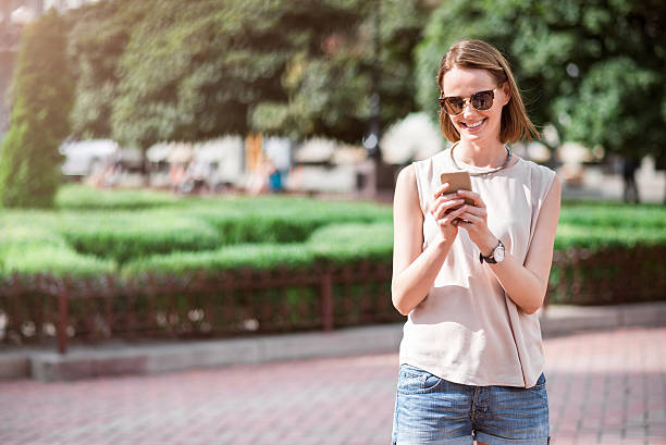 istock Pretty young woman using phone 605997700