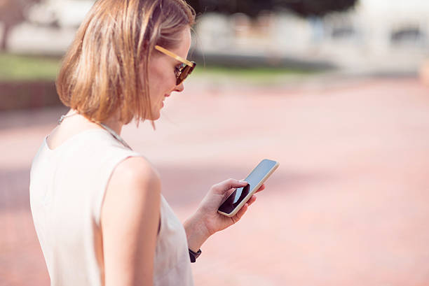 istock Attractive young woman using phone 605997774