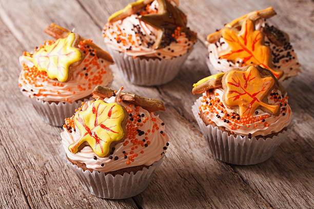 istock Cupcakes with autumn leaves close up on the table. Horizontal 605998332
