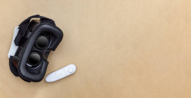 istock virtual glasses and joy stick on brown paper background 605998588