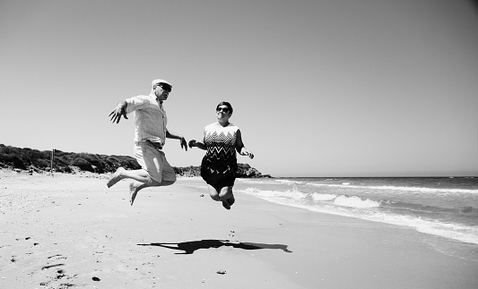 senior couple walking on the beach