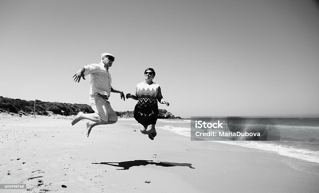 senior couple senior couple walking on the beach Retro Style Stock Photo