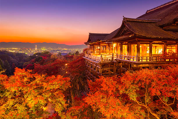 Kyoto in Autumn Kyoto, Japan - November 30, 2015: Tourists stand on the stage of Kiyomizudera Temple during the autumn season at dusk. The temple was founded in the 700's and the present stage structure dates from 1633. kyoto prefecture stock pictures, royalty-free photos & images
