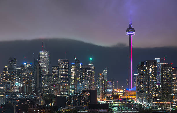 raincloud cuts through humid night time air over toronto, canada. - city night lighting equipment mid air imagens e fotografias de stock