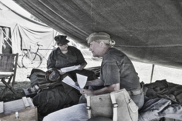istock Women Soldiers Reading Letters From Home 606002440