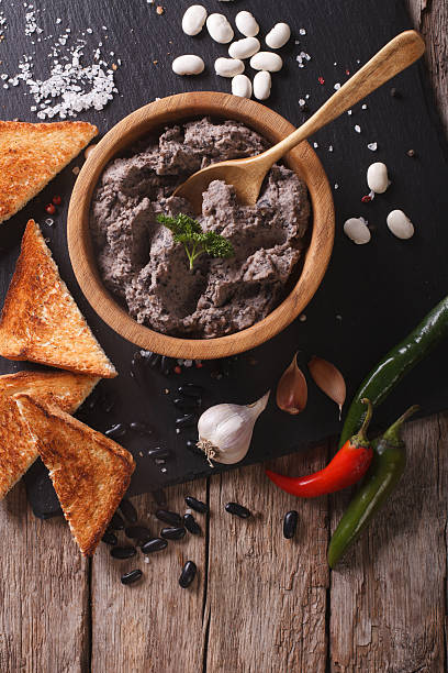 istock Frijoles refritos with ingredients close-up. vertical top view 606002614