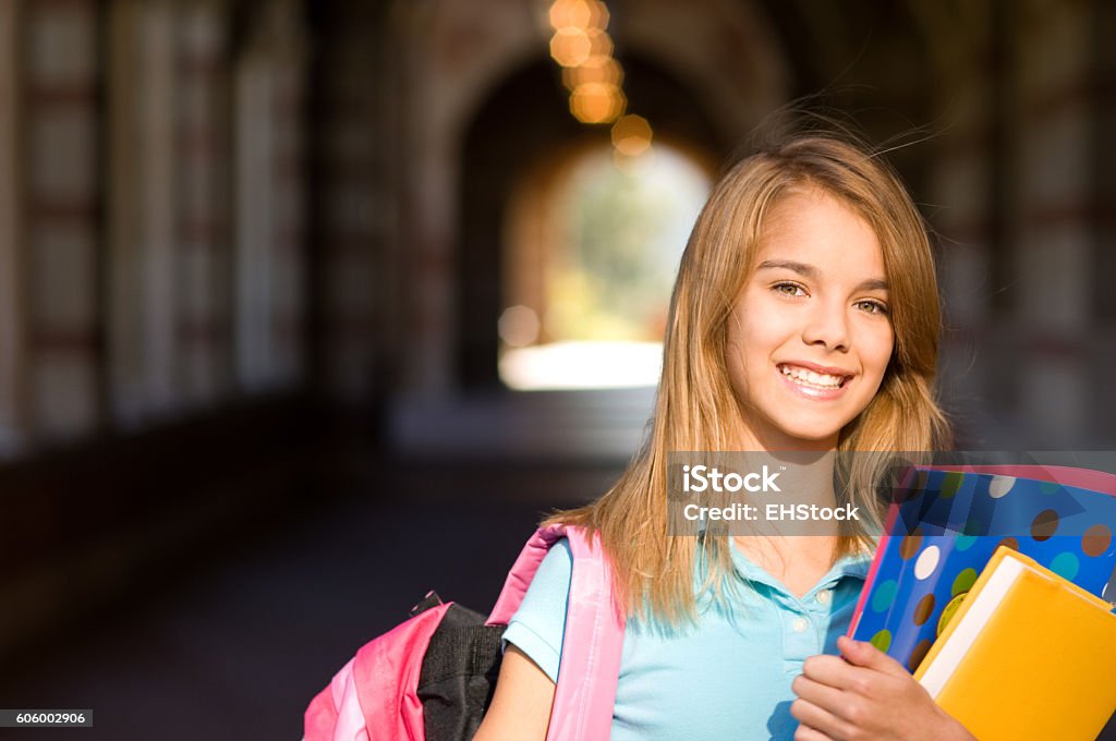 Teenage schoolgirl with books on campus Junior High Stock Photo