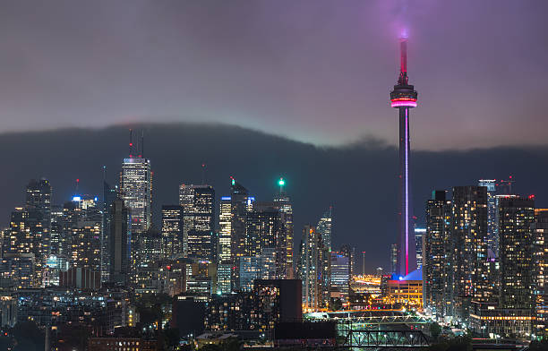 raincloud cuts through humid night time air over toronto, canada. - city night lighting equipment mid air imagens e fotografias de stock