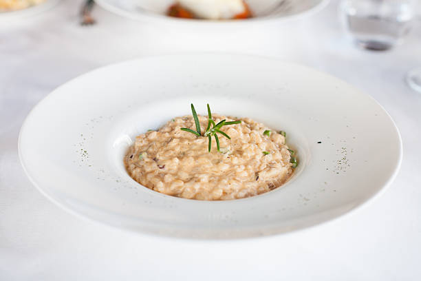 istock risotto with rosemary leaf in white dish 606005956