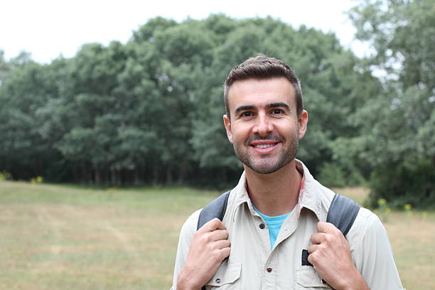 istock Happy handsome outdoorsy young man smiling 606006984
