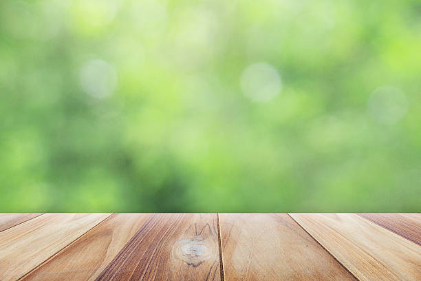 istock Close up wooden table with nature blurred background 606007726