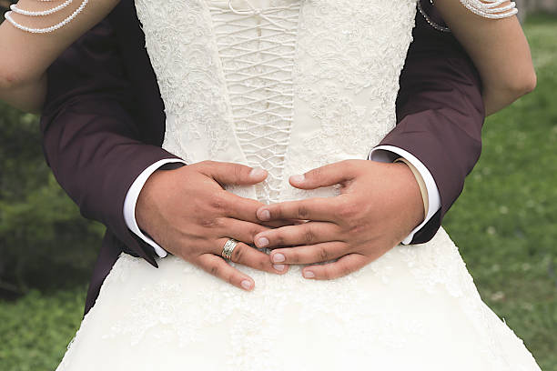 istock bride and groom hug, wedding dress 606009098
