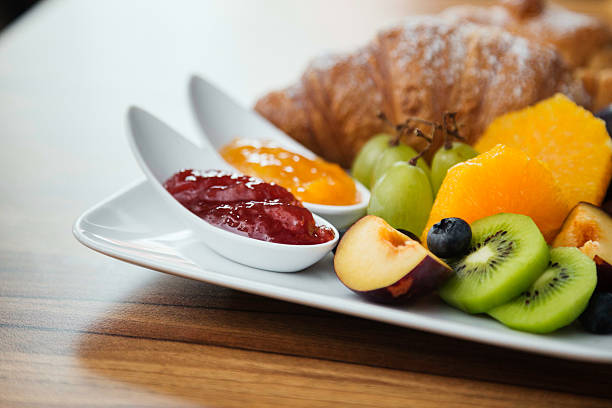 Continental breakfast with fresh fruit, jam and croissant. One of your 5-a-day. continental breakfast stock pictures, royalty-free photos & images