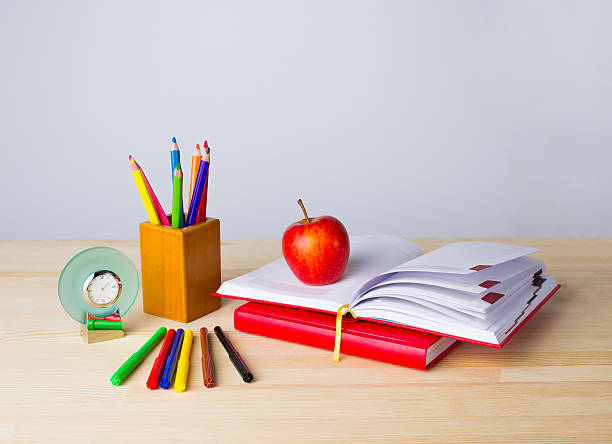 istock Back to school background with books, pencils and apple over 606013232