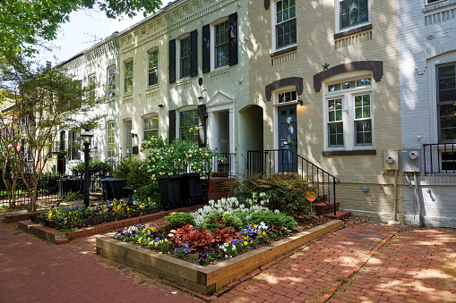 Washington D.C., USA - May 2, 2015: White building pictured in Georgetown district Washington D.C., United States of America. The city was approved by the signing of the Residence Act in 1970 and in 1801 it was organized. City did not belong to any state.