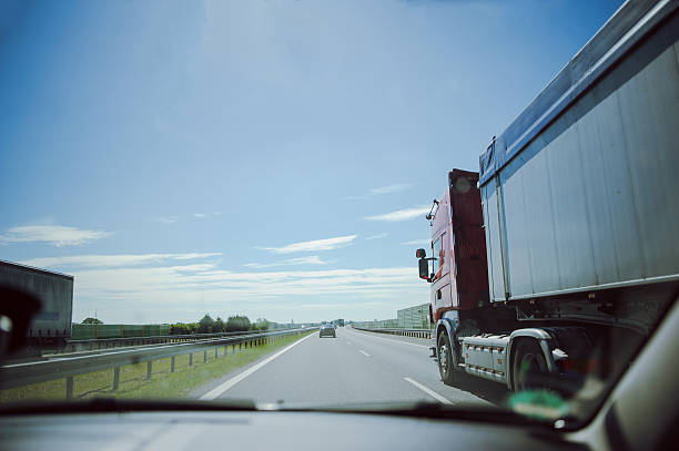 istock traffic on the freeway with cars and trucks overtaking 606013936