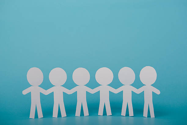istock abstract paper people holding for hands 606014822